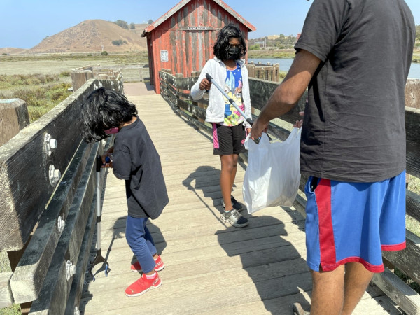 Riya and her family picking up trash at the Refuge. Photo courtesy: Deepti M.